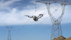 DJI Matrice 5TD in flight between transmission towers, camera gimbal facing forward