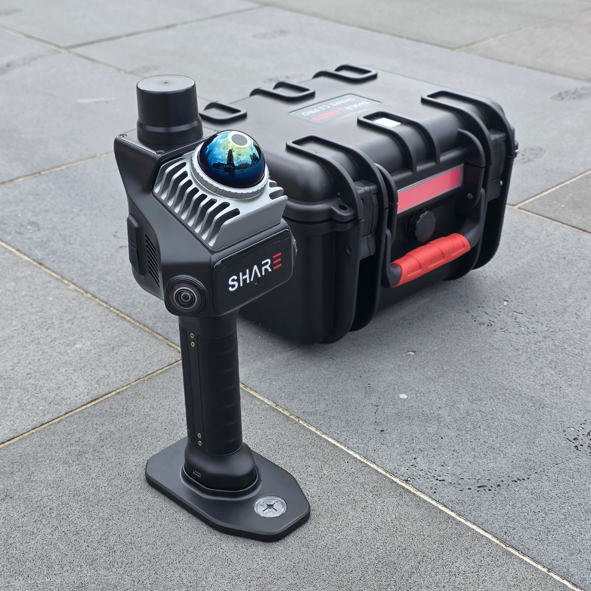 SHARE C1 Pro standing on its base beside the hard carry case