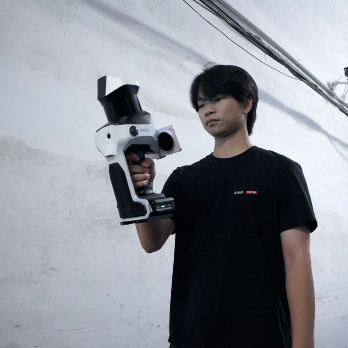 Operator holding the SHARE C10-32 while scanning inside a building